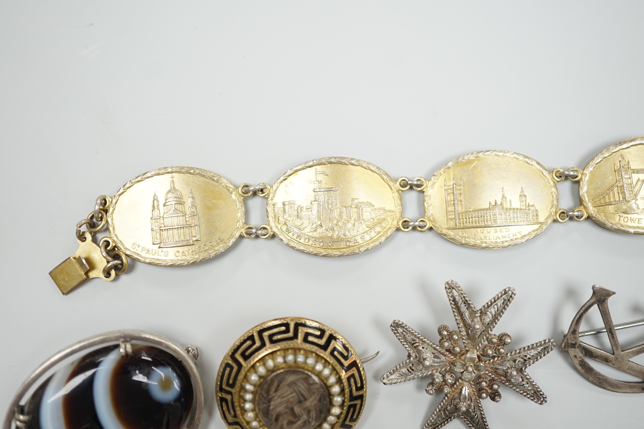A 1940's silver gilt bracelet, each link embossed with a famous English landmark, 19cm and a quantity of assorted jewellery including a Victorian silver and enamel commemorative brooch, banded agate set brooch and a gold